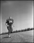 Photograph: [Football Player Number 74 in a Running Position]