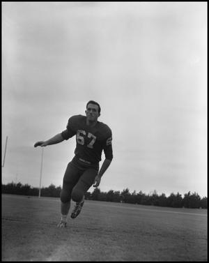 [Football Player No. 67 Running on the Field, September 1962]