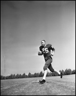 [Football Player Number 26 Running with a Football]