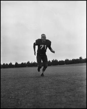 [Football Player No. 71 Running on the Field, September 1962]