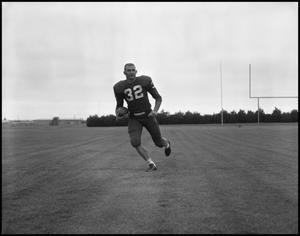 [Football Player No. 32 Running with a Football, September 1962]