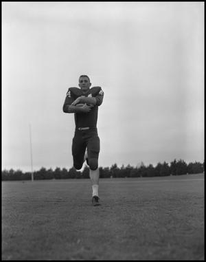 [Football Player No. 44 Running with a Football, September 1962]