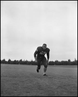 [Football Player No. 68 Running on the Field, September 1962]