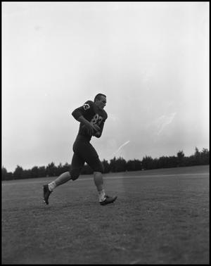 [Football Player No. 83 Running with a Football, September 1962]