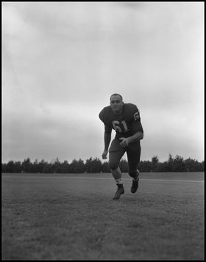 [Football Player No. 61 Running on the Field, September 1962]