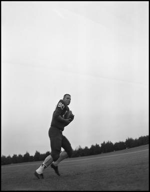 [Football Player No. 80 Running with a Football, September 1962]