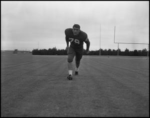 [Football Player No. 79 Running on the Field, September 1962]