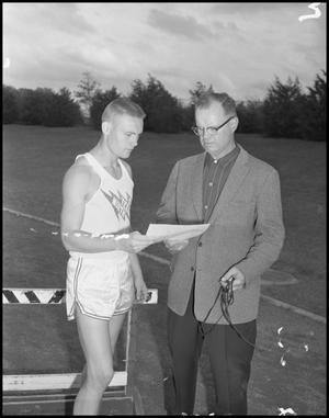 [Photograph of Track Coach with Student]