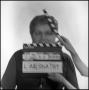 Photograph: [Portrait of Lewis Abernathy behind a clapperboard, 3]