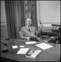 Photograph: [William G. Woods behind his desk]
