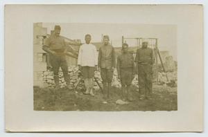 [Photograph of five men at construction site]