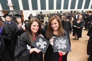 [Students with decorated mortarboards at UNT Commencement]
