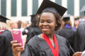 Photograph: [Student taking photo before UNT Fall Commencement]