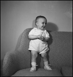 [Baby leaning against the back of a couch]