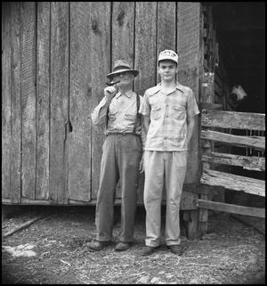 [Raymond and Pappy Clark in front of a barn]