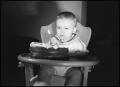 Photograph: [Baby blowing out a candle on a cake]