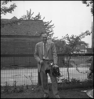 Primary view of object titled '[A man with a camera at the Clark wedding]'.