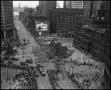 Primary view of [Aerial photograph of a parade marching downtown, 2]