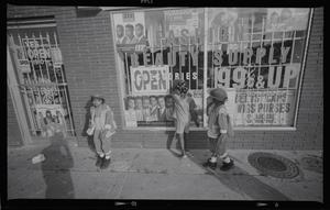 [Three children in front of beauty supply store]