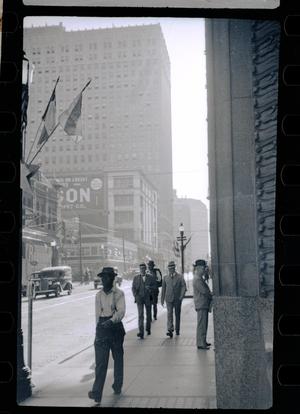 [Photograph of men walking on 7th & Main]