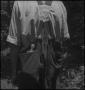 Photograph: [The back of a man's overalls]