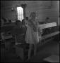 Photograph: [Young girl standing shyly before the class]