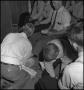 Photograph: [Men having their feet washed]
