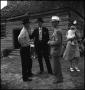 Photograph: [Three men chatting after church]