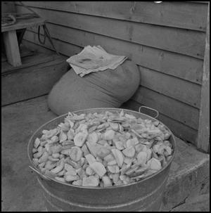 [Photo of a pot of potatoes next to a sack]
