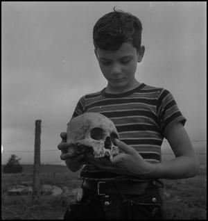 [Raymond Clark holding a human skull]