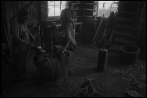 [Photograph of two men in a workshop, 1]