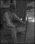 Photograph: [A man weaving a chair seat, 4]