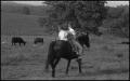 Photograph: [Photograph of a family on horseback in a field]