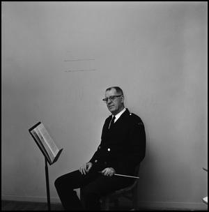 [Maurice McAdow sitting in a chair, 2]