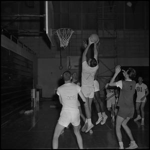 [Basketball player shooting the ball at an intramural game]