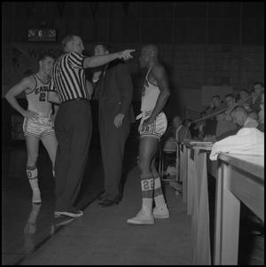 Primary view of object titled '[Basketball players talk to their coach and a referee]'.