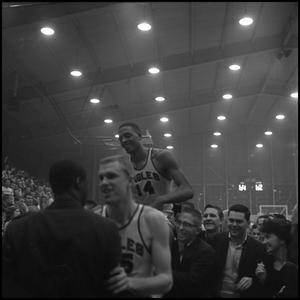 [Basketball player carried on supporters' shoulders]