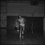 Photograph: [Willie Davis dribbling basketball on court]