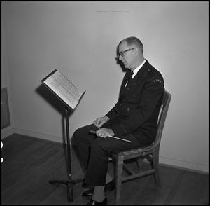 [Maurice McAdow sitting in a chair, 6]