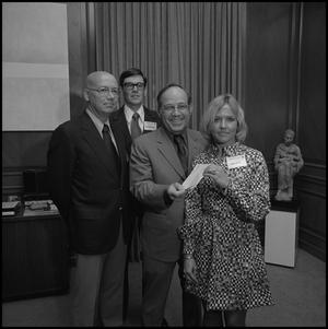 [President Nolen receiving a check from representatives of Atlantic Richfield]
