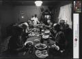 Photograph: [People gathered around a dinner table]