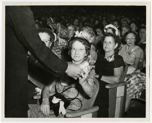 Primary view of [Woman receiving gift on Old Maid's Day]