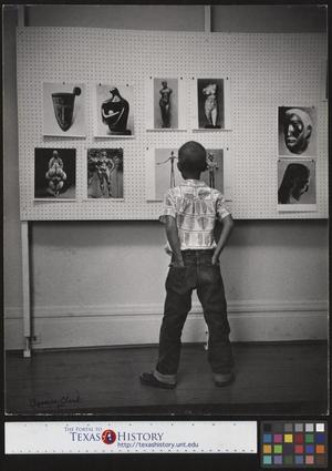 [Young Boy studying artwork]