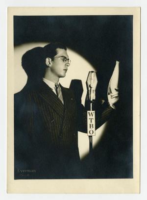 Willis Conover standing at a WTBO microphone
