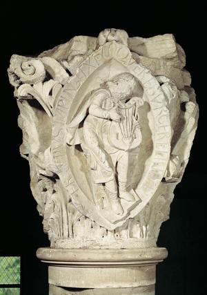 Capital depicting the Third Key of Plainsong with a lute player