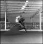 Photograph: [Distant view of cowboy riding rearing horse]