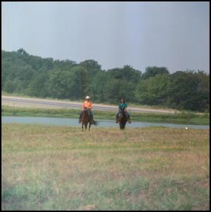 [Two People Riding Horses]