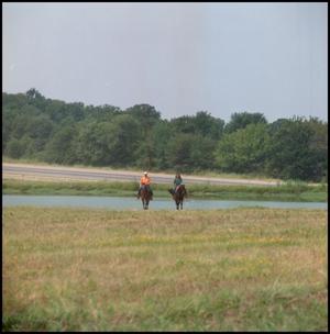 [A Man and Woman Riding Horses]