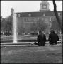Photograph: [Students Sitting near Administration Building]