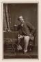 Thumbnail image of item number 1 in: '[Photograph of Charles Dickens sitting at table with book]'.